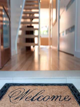 welcome-mat-with-door-open-and-stair-case